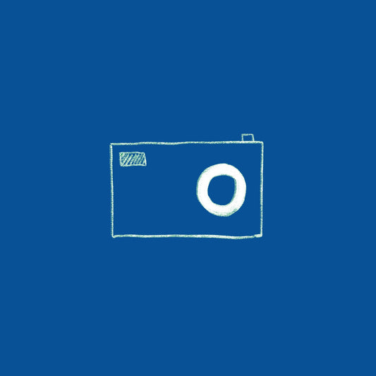 A hand-drawn sketch of a minimalist camera is drawn on a blue background in white ink. 